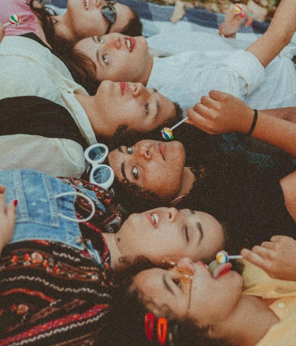 A group of diverse people relaxing and smiling after a yoga class.